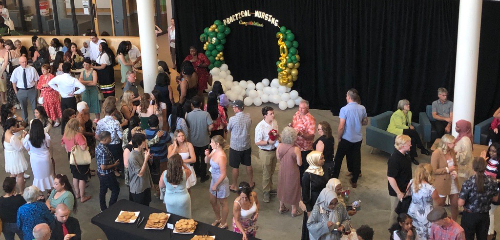 Graduates and their families mingle during a reception