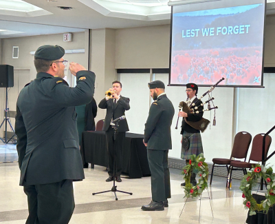 trumpet and bagpiper at the ready as soldier salutes