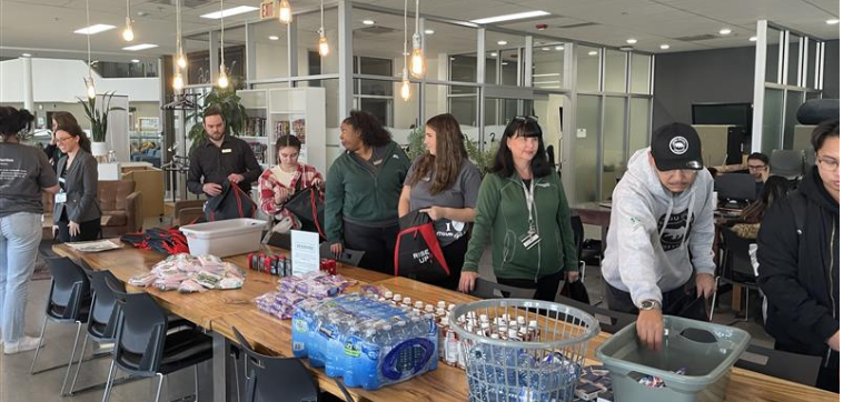 Algonquin College student and employees help prepare bags for the unhoused community. 