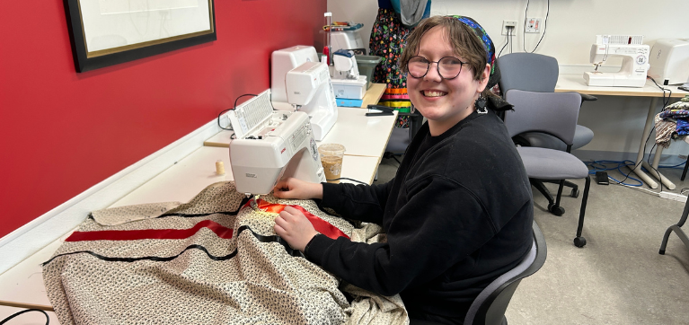 student works on creating a ribbon skirt
